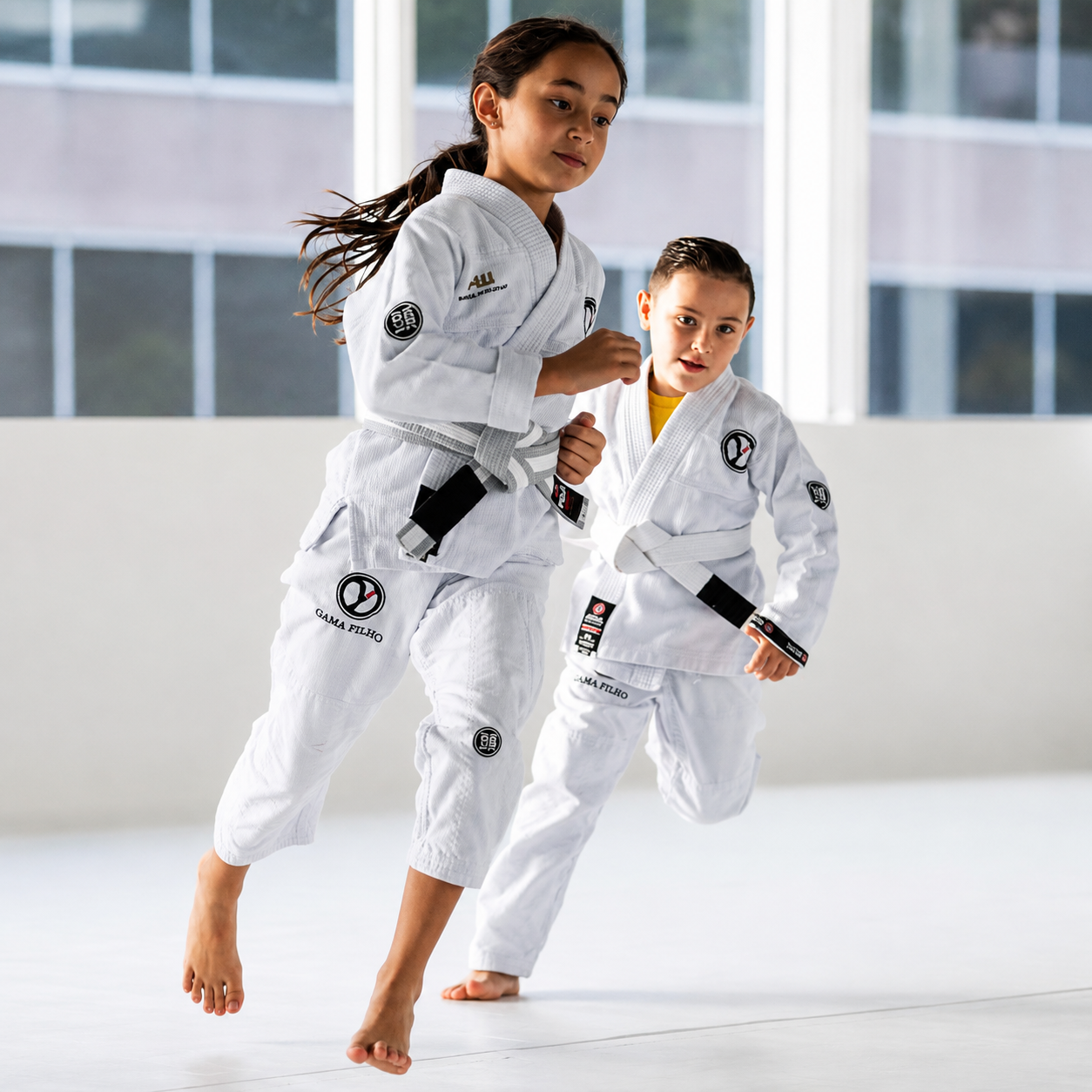 Two Little Champions students training Brazilian Jiu-Jitsu in Gama Filho gis